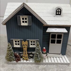 Animated musical ski chalet Winter Wonderland and door opens reveals skier